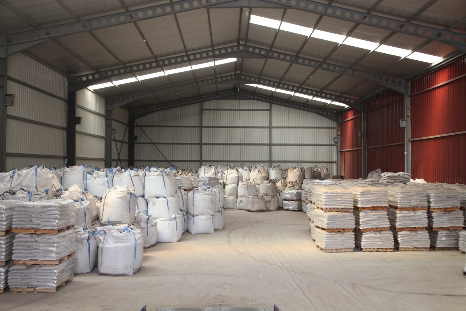 Warehouse with packaged material and bulk bags